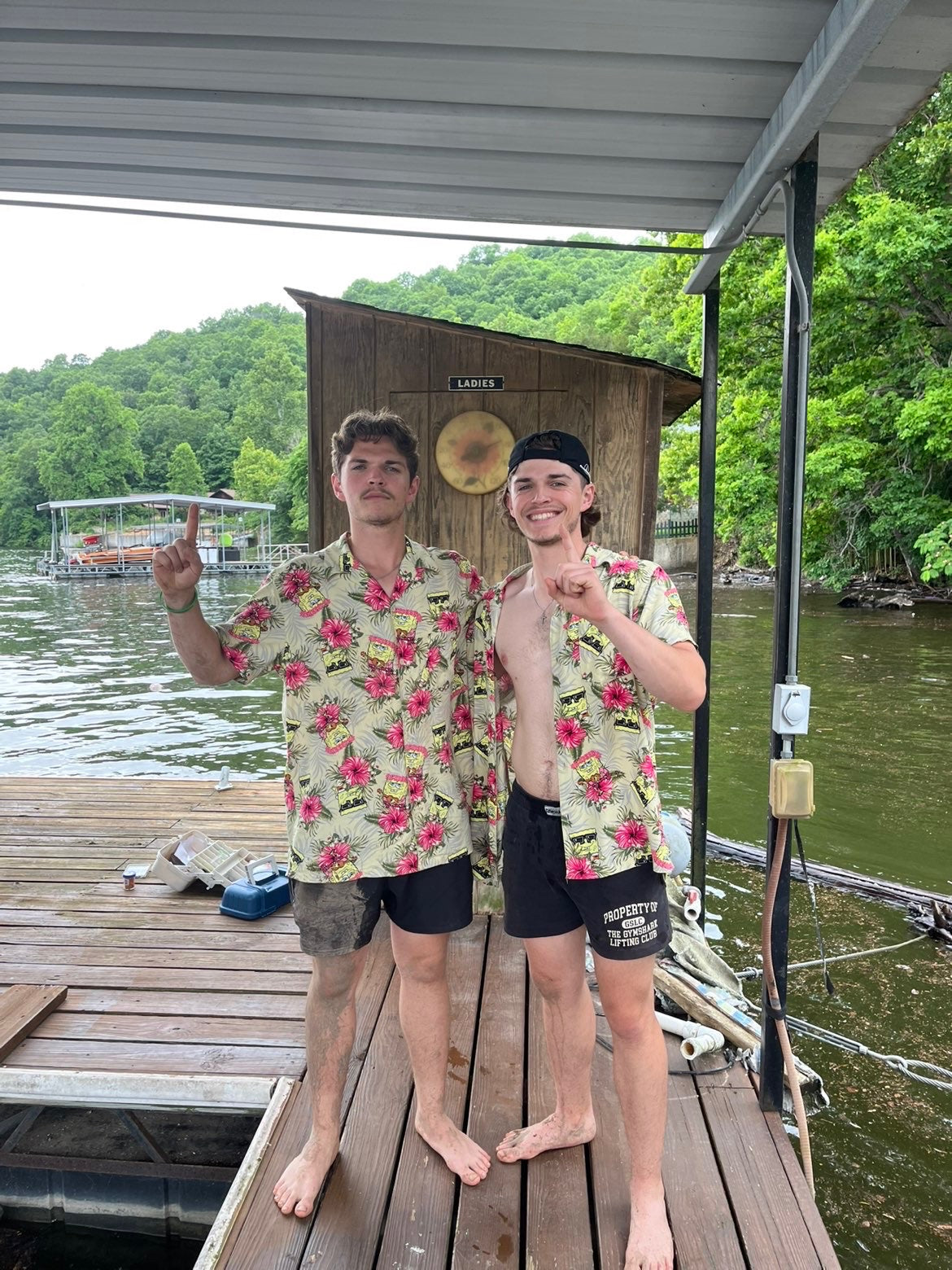 Andrew and Michael on a dock in matching floral shirts
